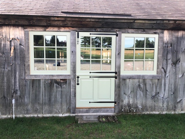 white historically matched door on wooden building
